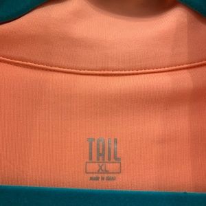 Tail 1/4 zipper top. Peach. NWT 91% polyester 9% spandex. 23 in arm 26in body.
